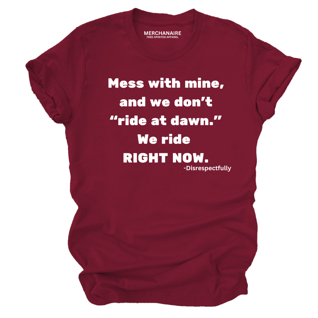 Burgundy t-shirt featuring bold text: ‘Mess with mine and we don’t ride at dawn, we ride right now.’ This protective and empowering design is perfect for those who celebrate melanin pride, unity, and unapologetic strength. Ideal for casual wear, statement clothing, and making a bold impression.
